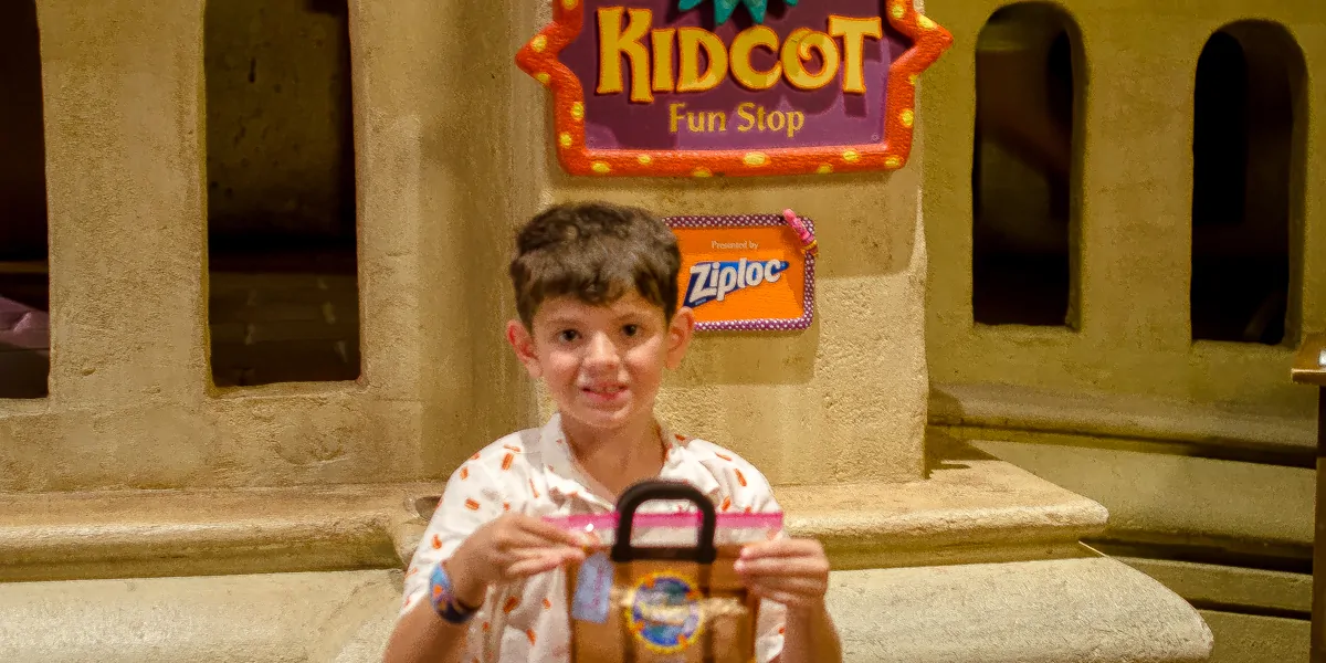 Jackson gets his Ziploc Kidcot Fun Stop bag in Mexico at Epcot World Showcase