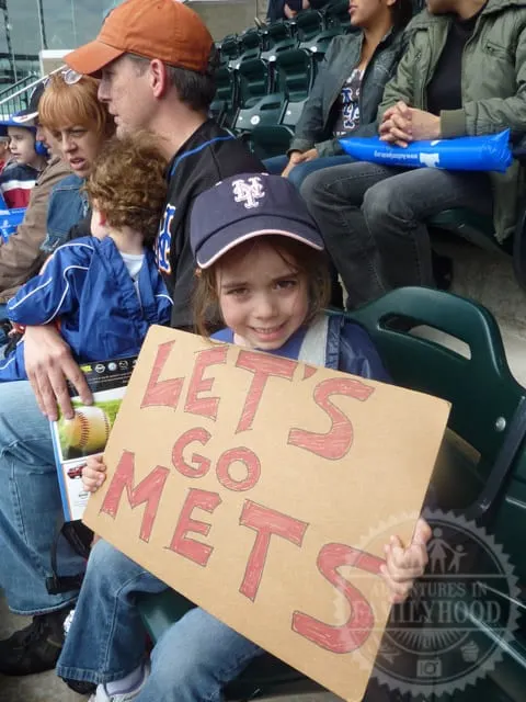 Bella holding her Let's Go Mets sign at the ballpark