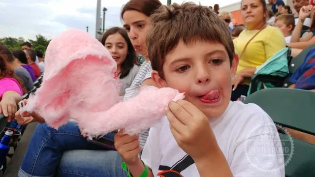 Jackson enjoys cotton candy at the ballpark during baseball game