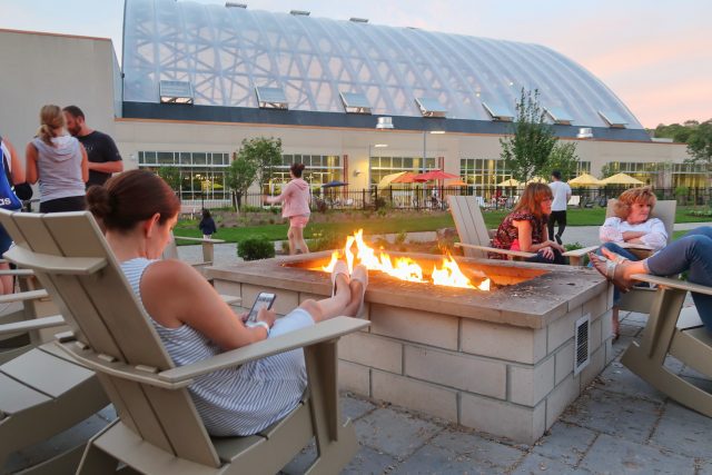 Lisa sits back with her feet up by the fire pit in the commons area of Kartrite Resort